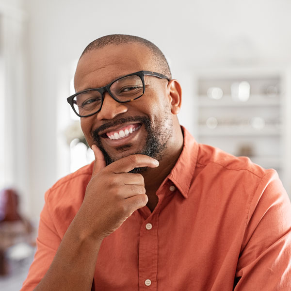 man smiling with hand on chin