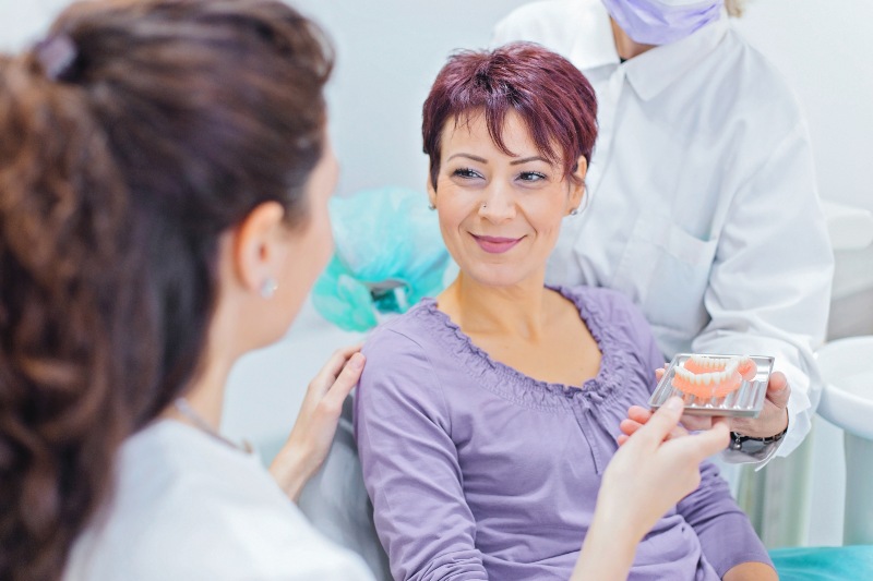 First-time denture consultation using a dental model in New Lenox, IL