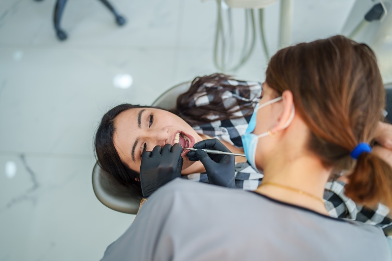 Dentist performing a dental implant treatment at Elite Smiles of New Lenox in New Lenox, IL