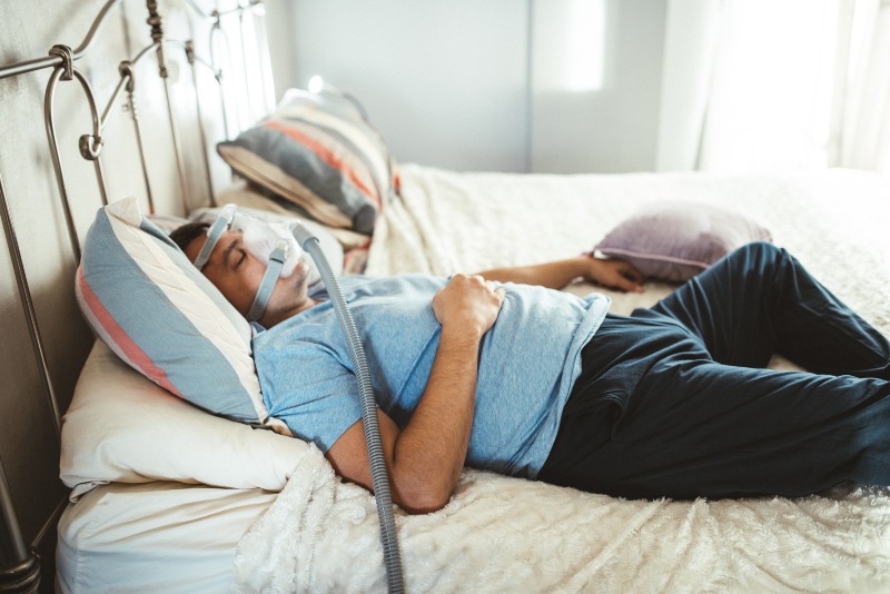 Sleep apnea patient using CPAP during rest in New Lenox, IL